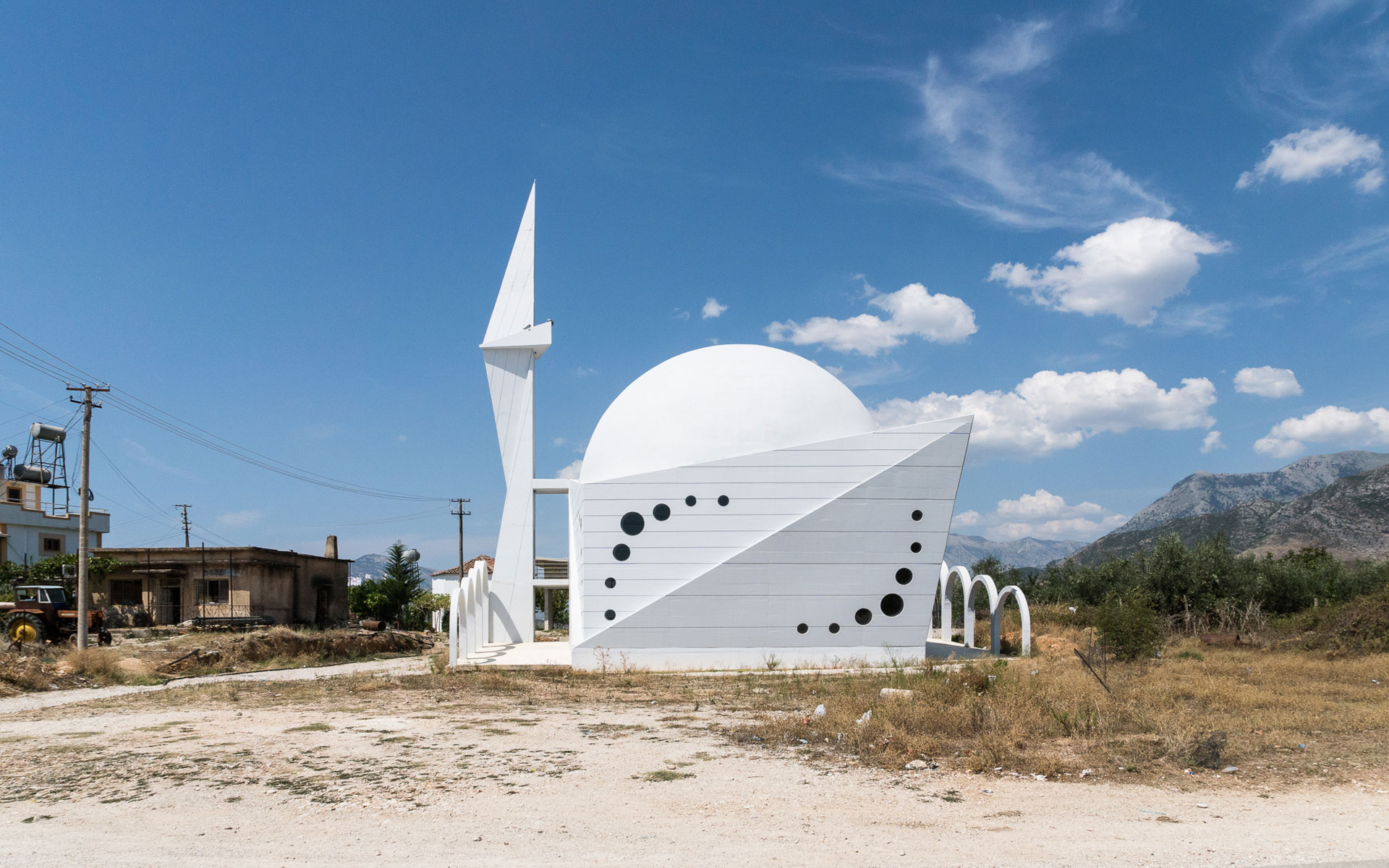 Take a moment to reflect on the pristine, geometric beauty of this roadside Albanian mosque
