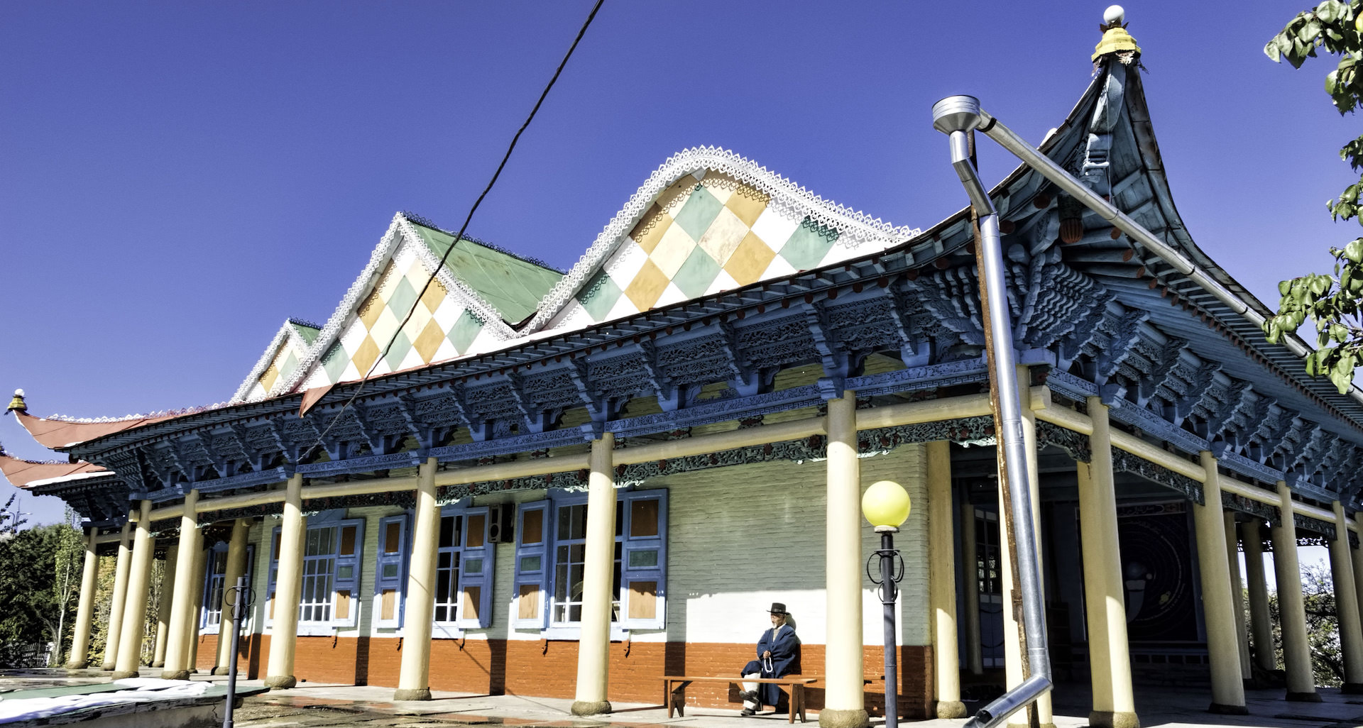 Admire the brightly painted Dungan Mosque near the serene Lake Issyk-Kul | The Escapist 