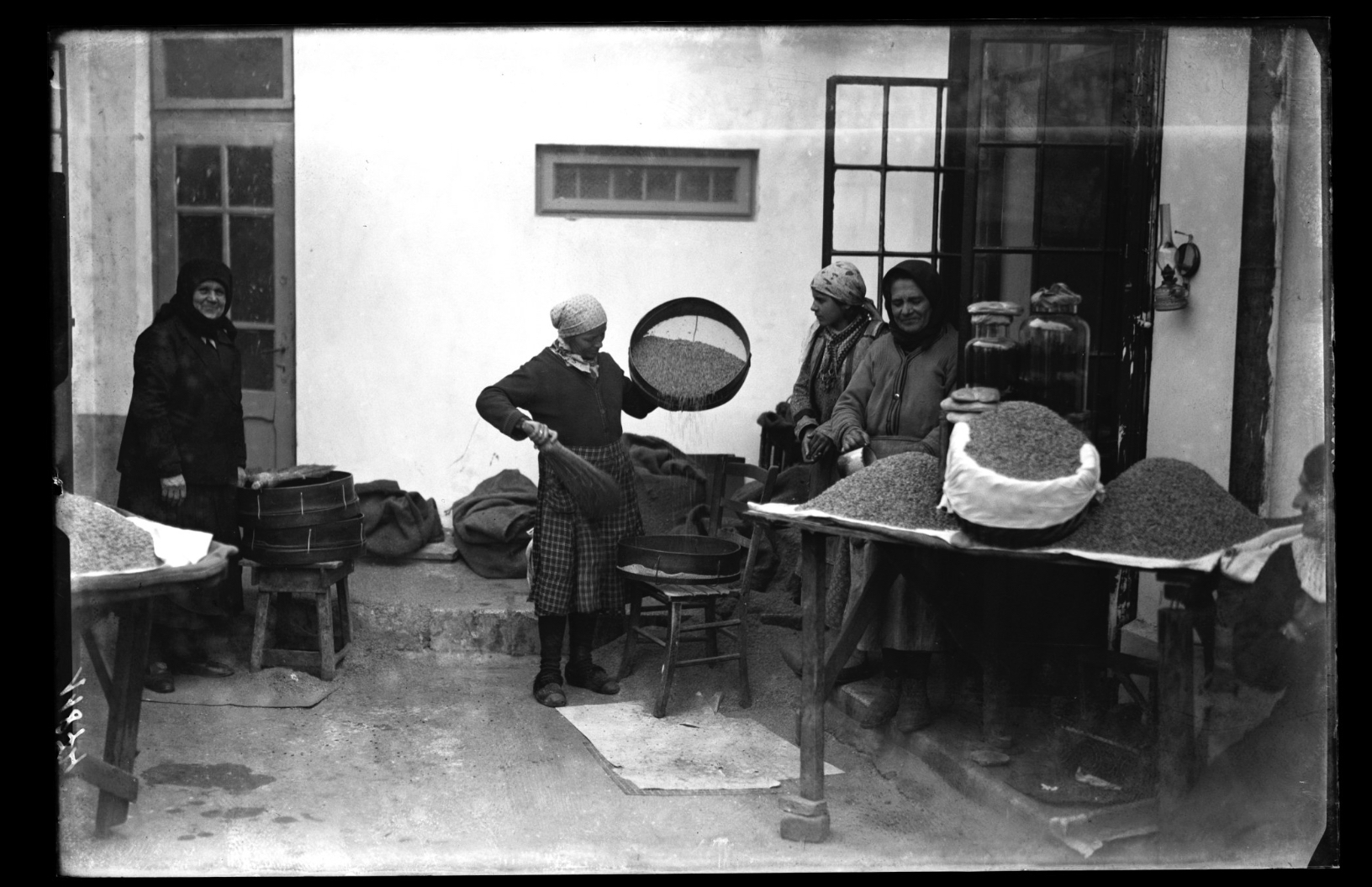 Women preparing the pearl barley for Romanian dish coliva, 1920-40