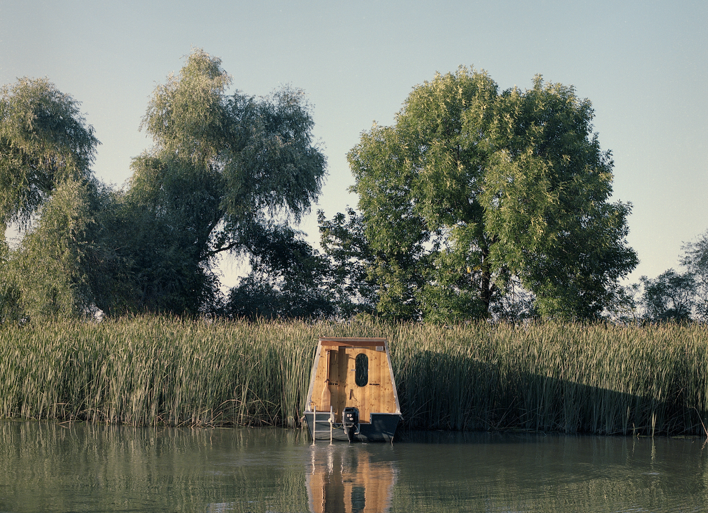 Built in a Polish nature reserve, this minimalist house blends into its natural home