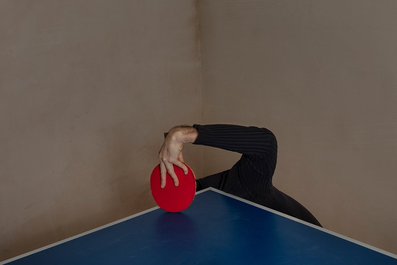 Prozac: Self-Portrait with a Tennis Racket. "Staying with his parents and lacking income as well as energy, he felt like a burden. Here he’s cowering under the table tennis table, hardly even visible as a human."