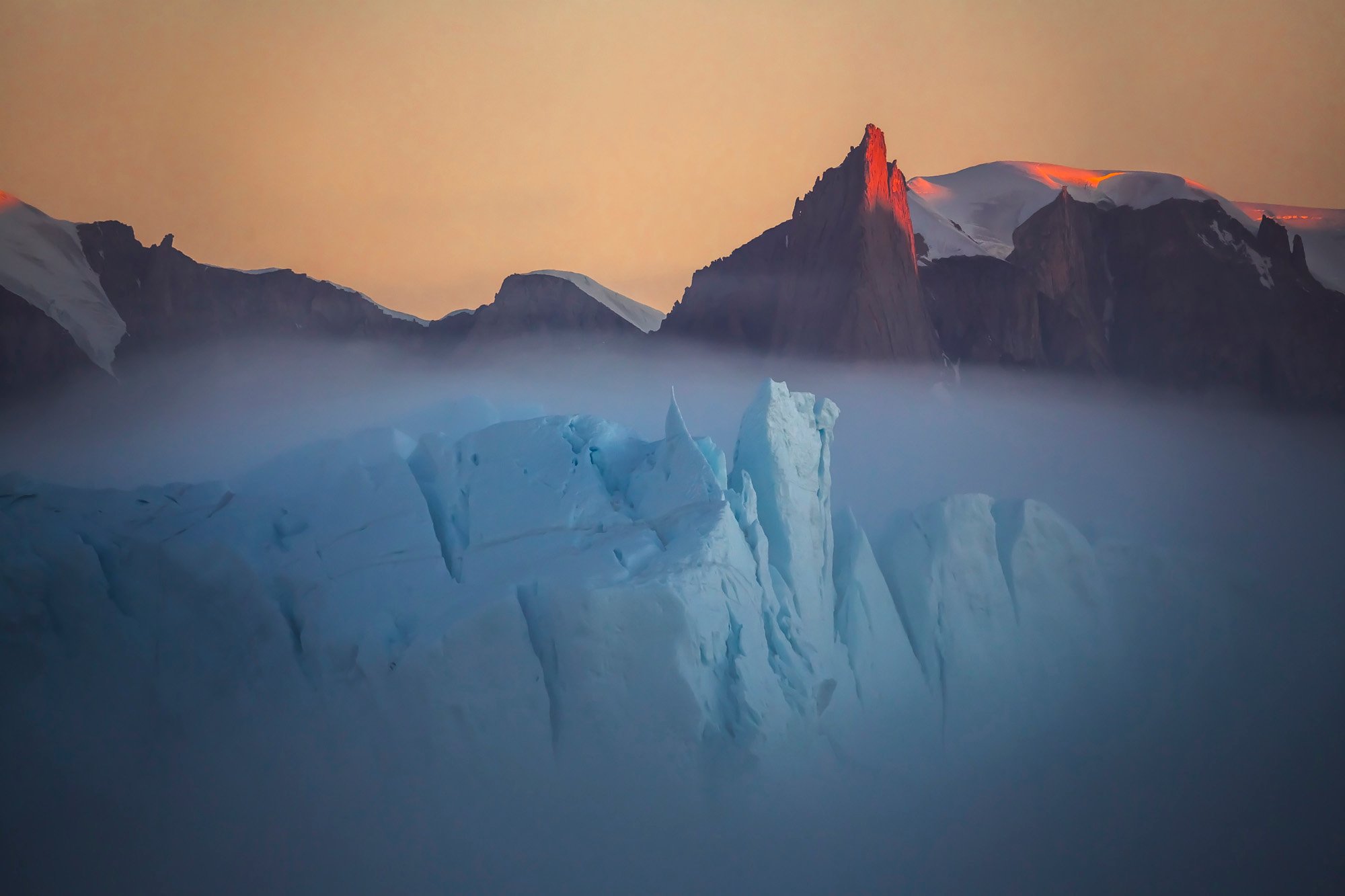 "Fog over the iceberg in Greenland. A very rare natural phenomenon. This is a huge iceberg that swam past the coast, shrouded in fog." Image: Vladimir Alekseev/www.tpoty.com
