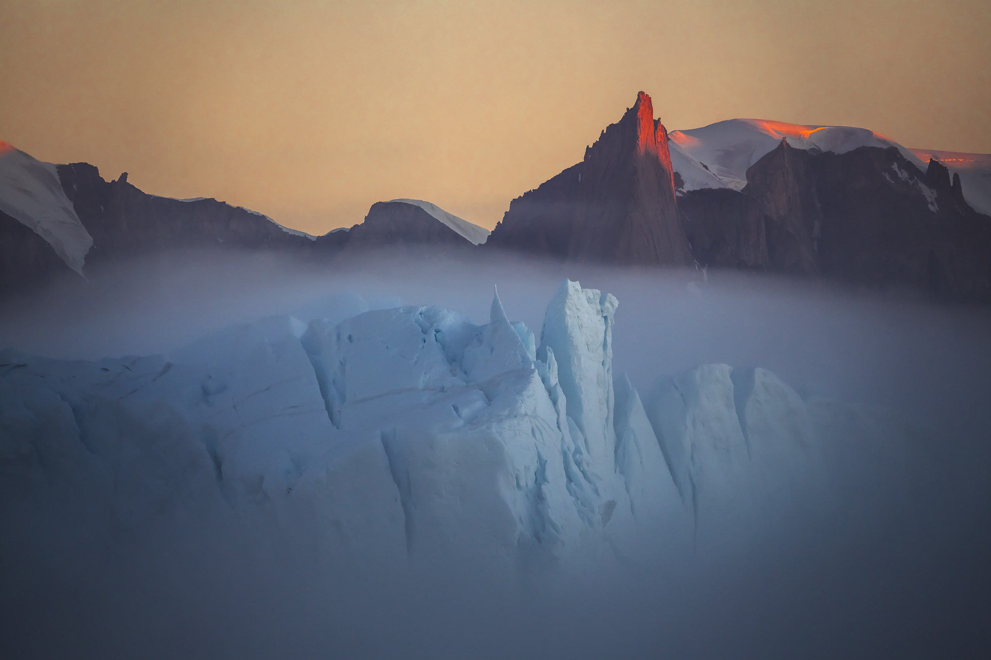 "Fog over the iceberg in Greenland. A very rare natural phenomenon. This is a huge iceberg that swam past the coast, shrouded in fog." Image: Vladimir Alekseev/www.tpoty.com