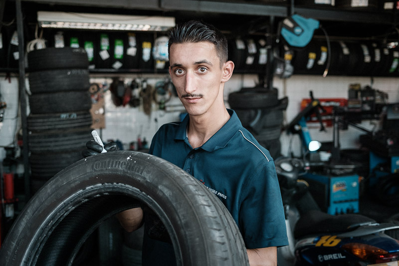 Ghiță, 20, came to Portugal from Poienile de sub Munte, Romania, with his parents six years ago. He works at Auto Vasile Pneus, the wheel service shop of another Romanian from the same village. Loulé, Portugal, August, 2020. Image: Cosmin Bumbuț 