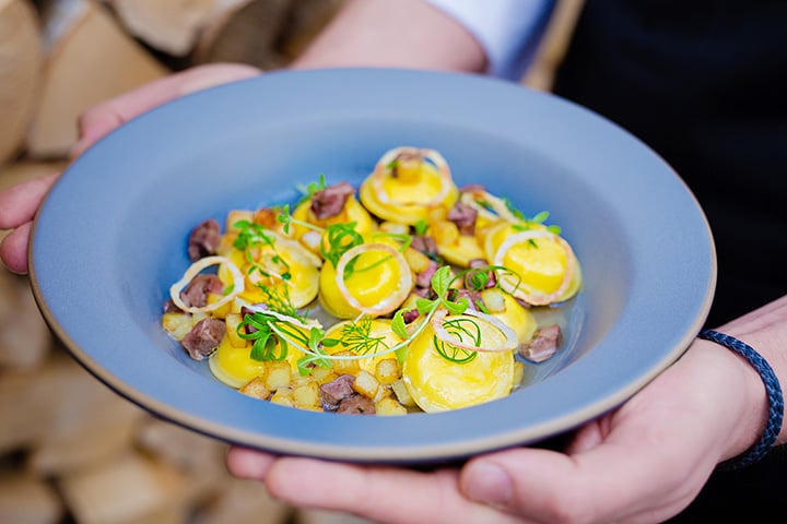 Ravioli with soured cream, lamb's heart and baked potato served at Twins