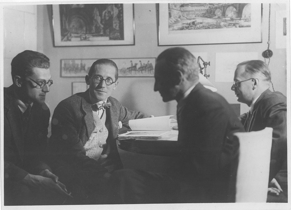Le Corbusier (2nd from left) sitting with Soviet modernist Andrei Burov (far left) in 1928