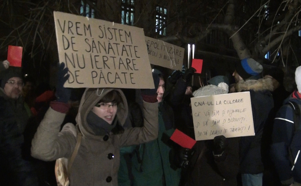 “We want a health system, not forgiveness for our sins” — an anti-Church protester in Bucharest. Image: epochtimes-romania