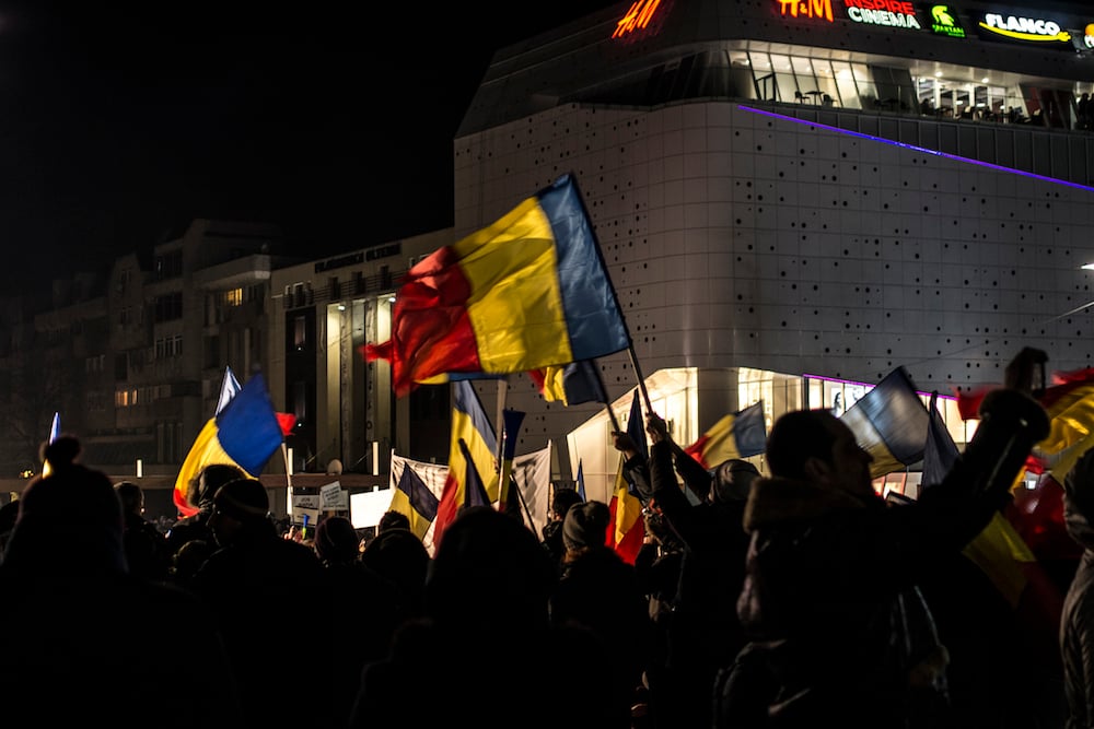 Romanian flags at a protest in Craiova. Image: Albert Dorin under a CC licence