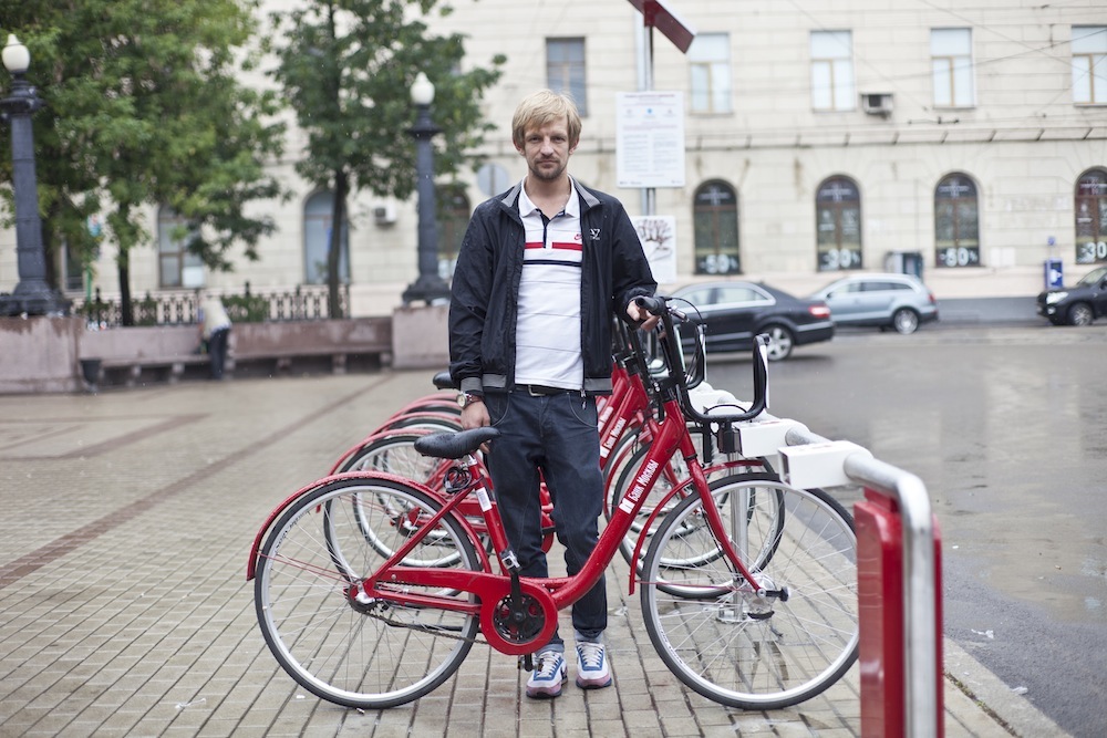 Vadim Hazov standing next to a bike rental station in Moscow