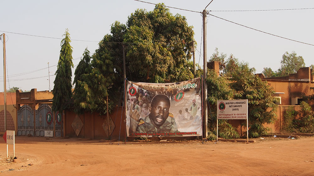 Propaganda poster with image of Sankara on street corner. Image: Sputniktilt under a CC licence