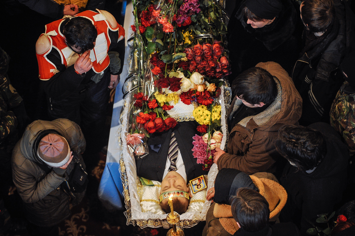 Mourners gather at the funeral of 25-year-old Mikhail Zhiznevsky, one of the protesters to die during the demostrations 