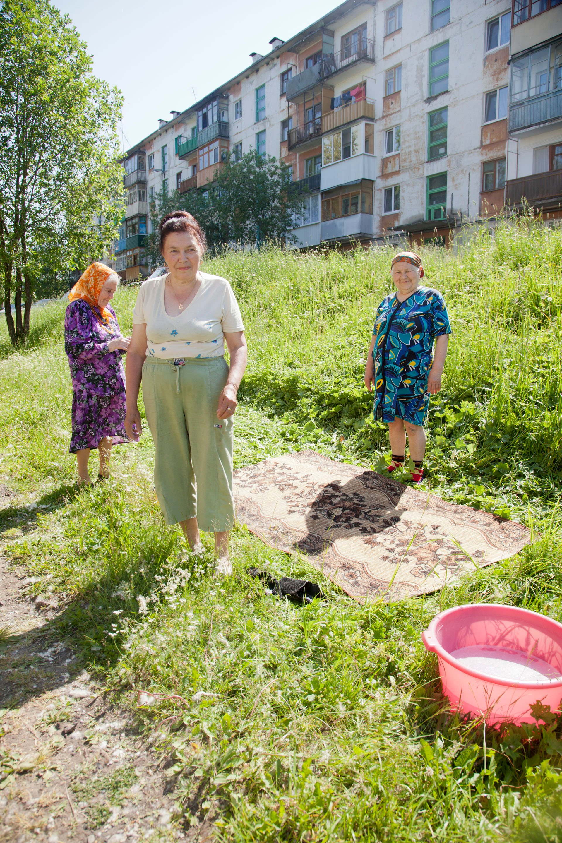 Women scrub the rugs of their homes one morning in Kizel