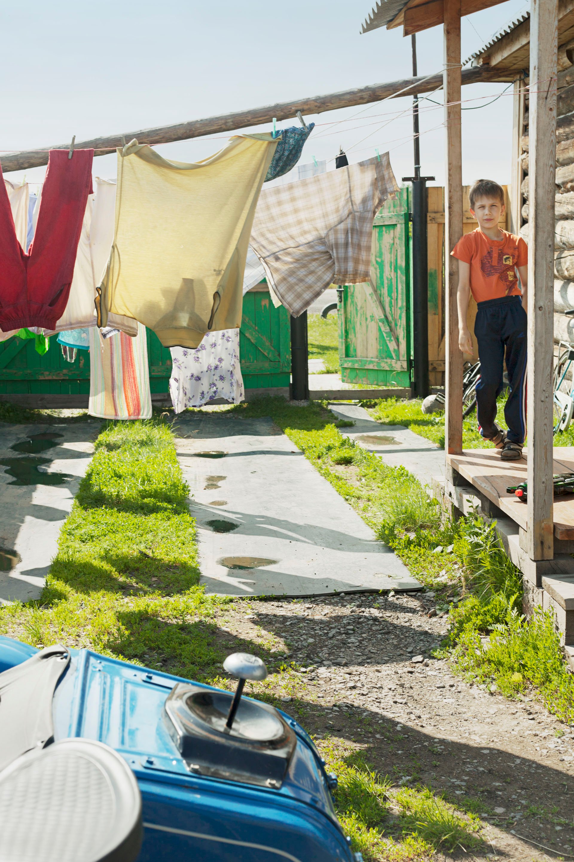 A boy standing outside of his home, Krasnouralsk