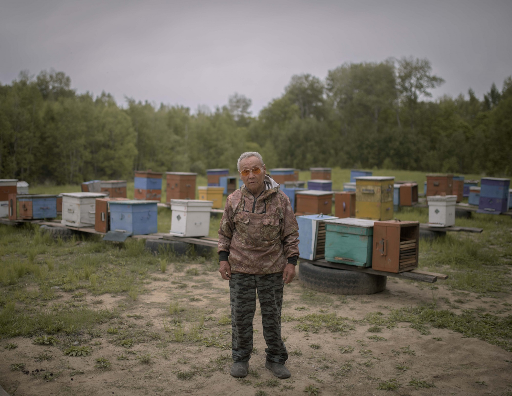 Leonid Makdyovich Beldy pictured beside his bee-hives in the village of Dada 