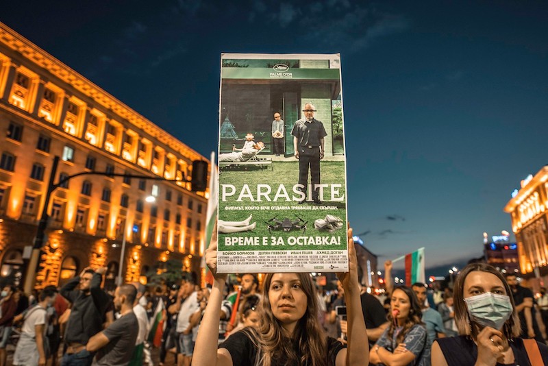 A poster for Bong Joon-Ho’s film Parasite, superimposed with the faces of different Bulgarian politicians. The added images of a drone and stacks of cash in the poster's foreground are also references to a recent corruption scandal.