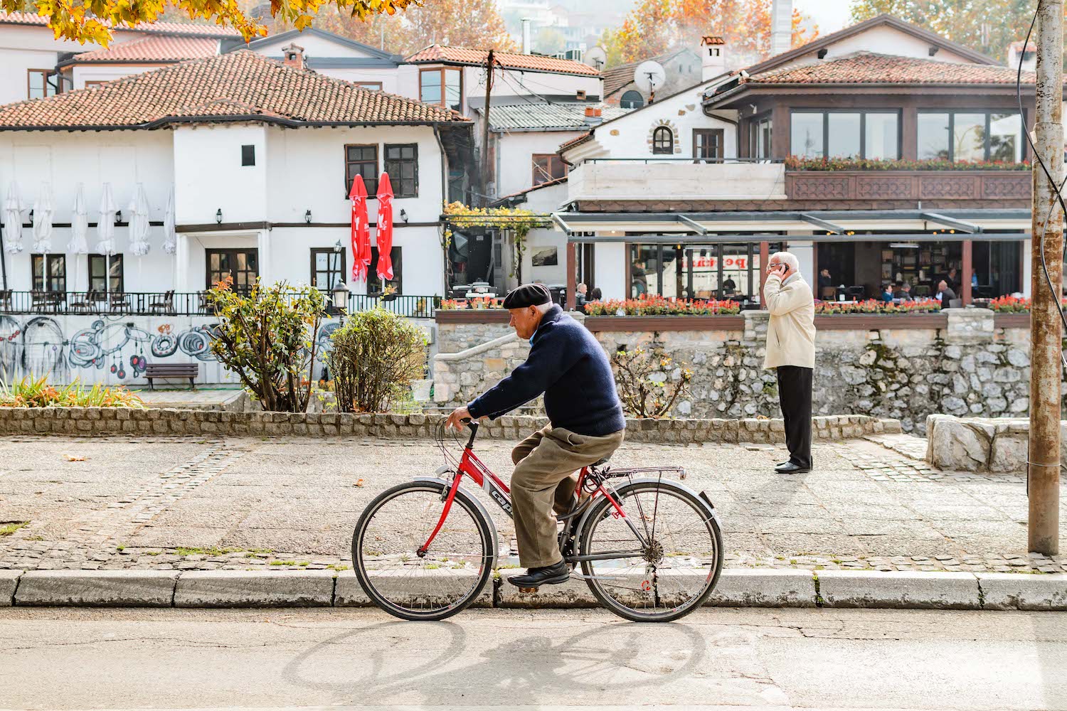 A man rides his bicycle through Prizren