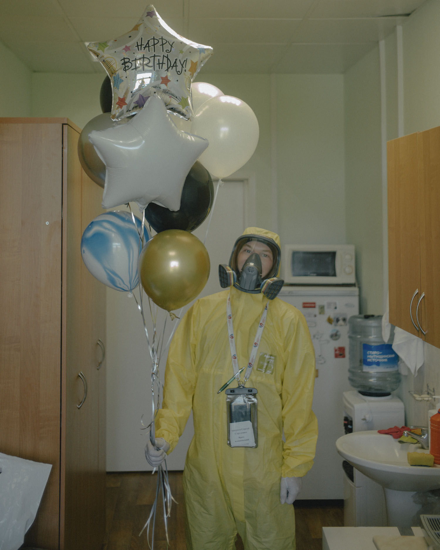 Doctor Sergey Andreev with balloons given to him on his birthday. From the series Just Stand and Look by Nanna Heitmann (2020). Image: Magnum Photos 