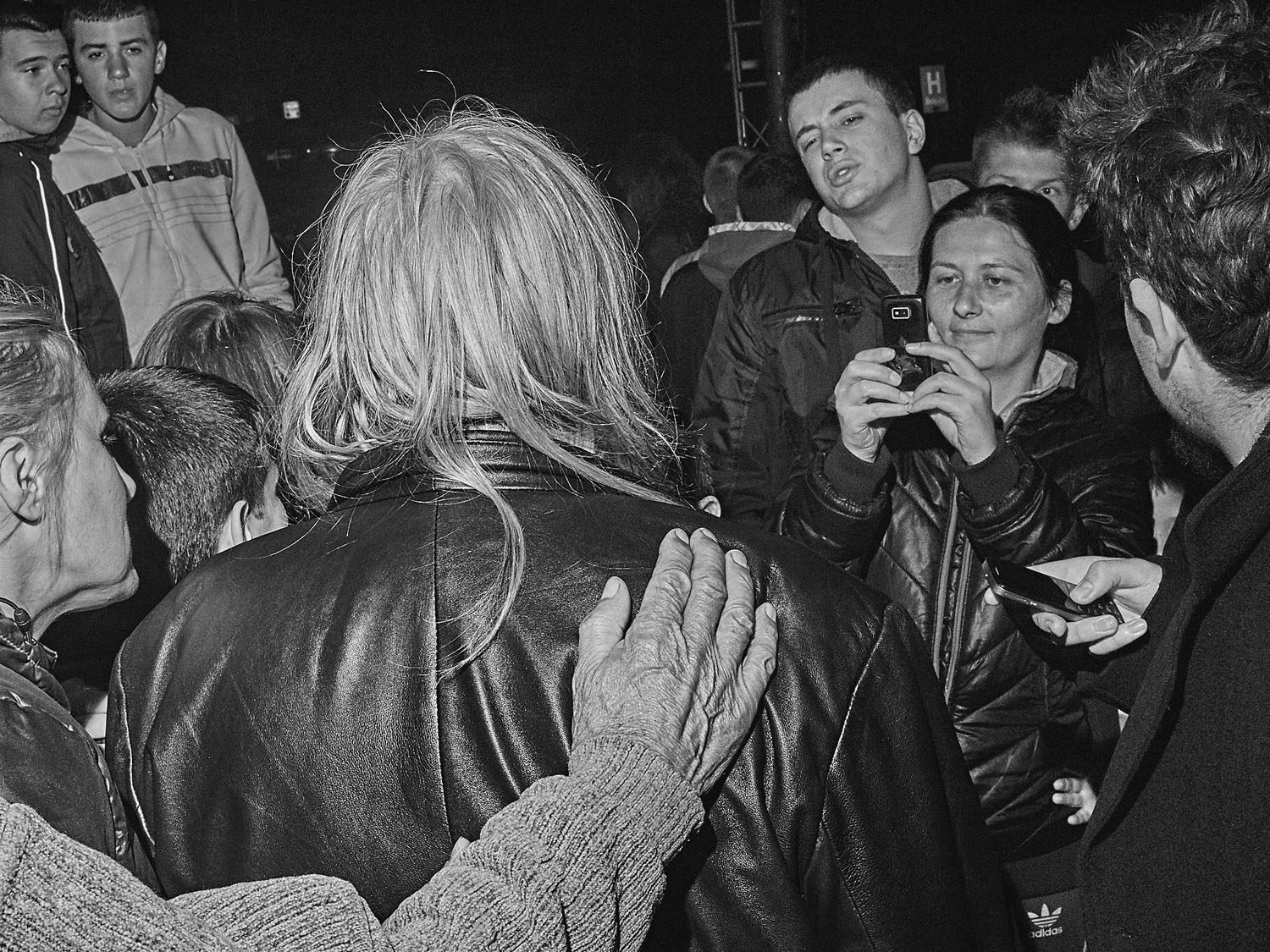 People welcome Bora Djordjevic, the frontman of nationalist band Riblja Cobra, in Mitrovica the night before elections in Kosovo