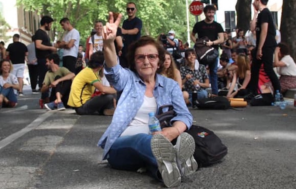 A protestor against the theatre's demolition blocks a road in Tirana