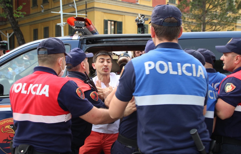 A protestor demonstrates against the demolition of the National Theatre building in Tirana