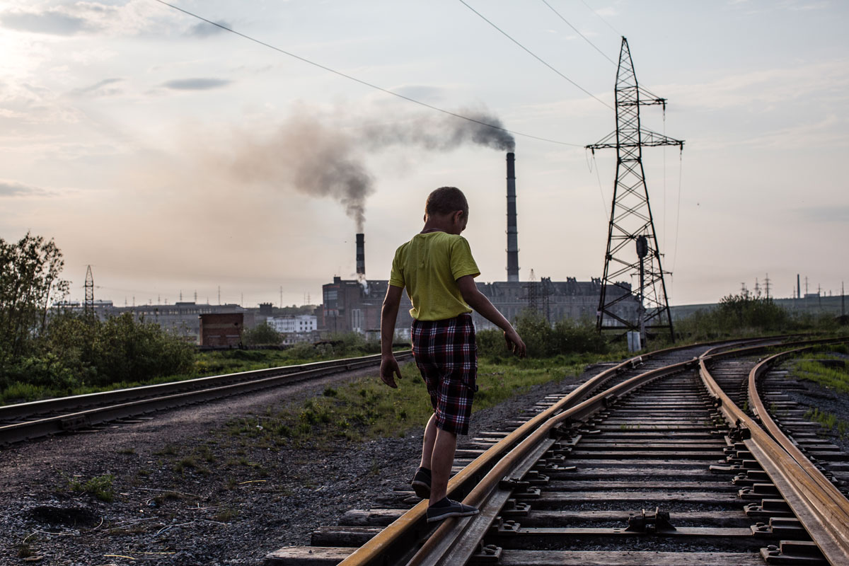  A boy walks on a railway track. Since the mid-2000s, many of Vorkuta's schools and kindergartens have been abandoned and closed