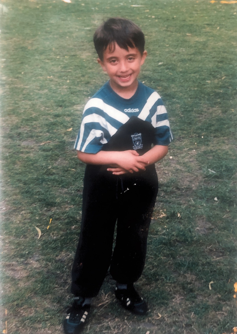 Din Havolli as a child, wearing his Liverpool shirt. Image courtesy of the author
