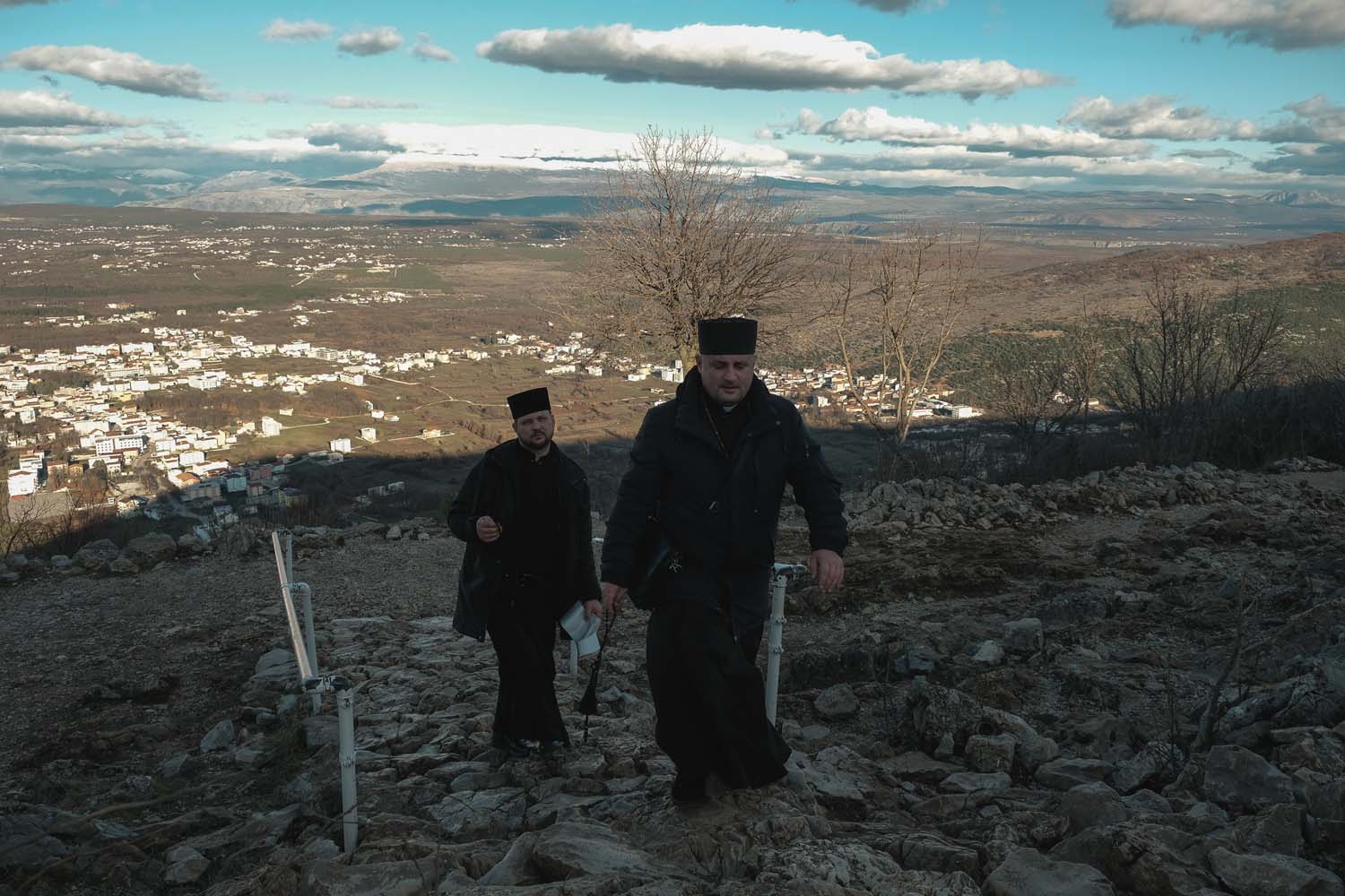Priests walk towards the summit of Mount Križevac.