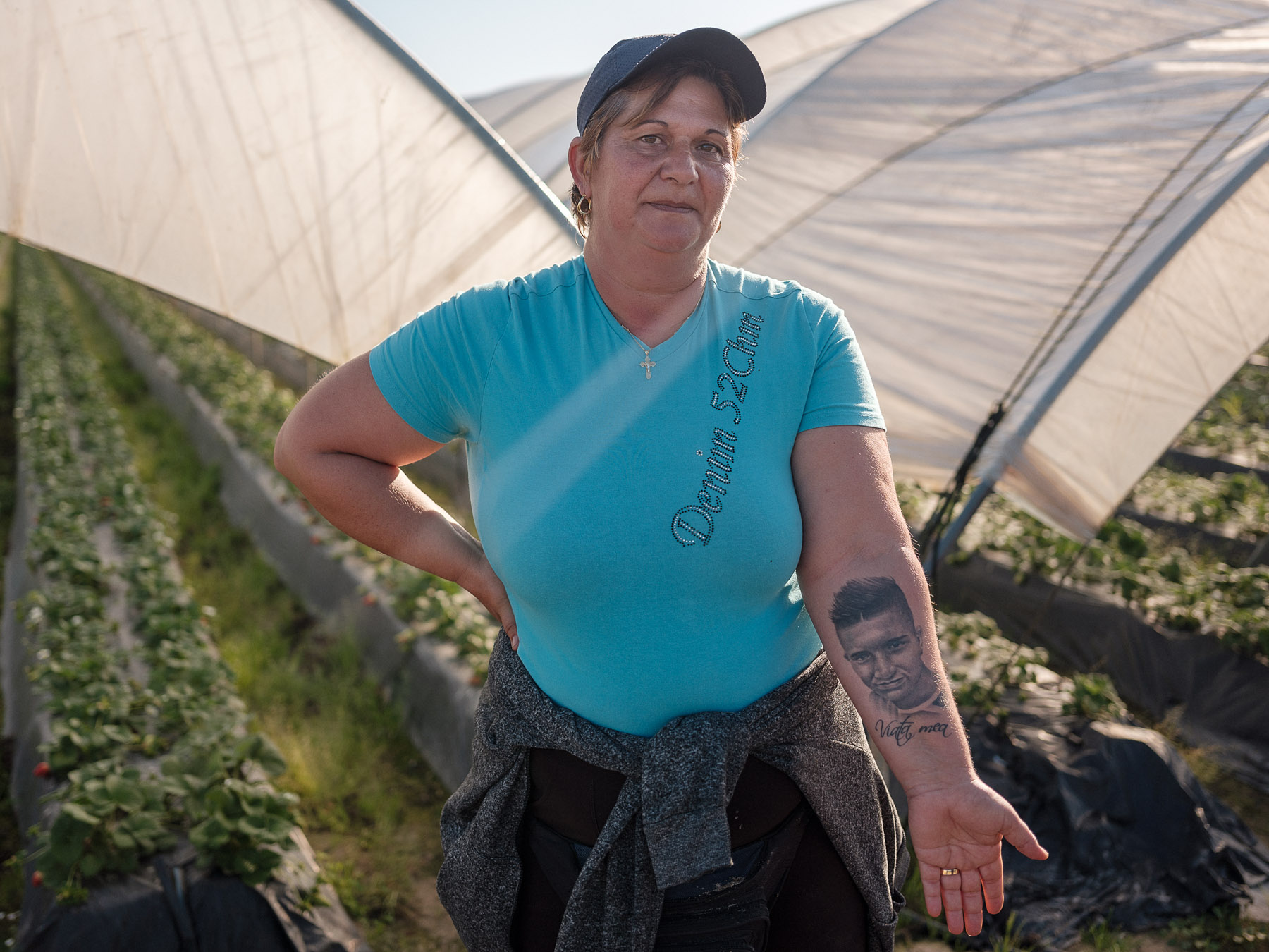 Corina left Romania when her son was only 3, to pick fruit in Spain. With that money, she built 2 houses in her Romanian village — one for herself, and the other one for her child. But the boy died at 17. Corina tattooed his face to feel close to him  