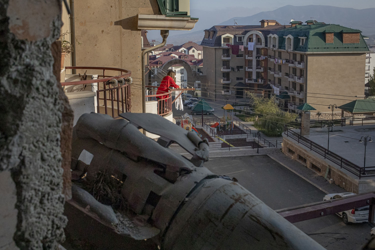Stepanakert’s neat backyards and the remains of a rocket on a family’s balcony. While a lady was hanging her laundry on the balcony across, the HALO trust was removing this piece from the apartment.