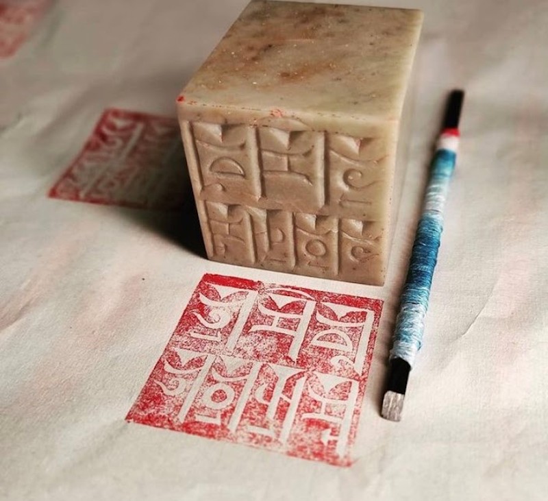 A stamp created by Zhamsoev with the Buryat language written in Mongolian script.
