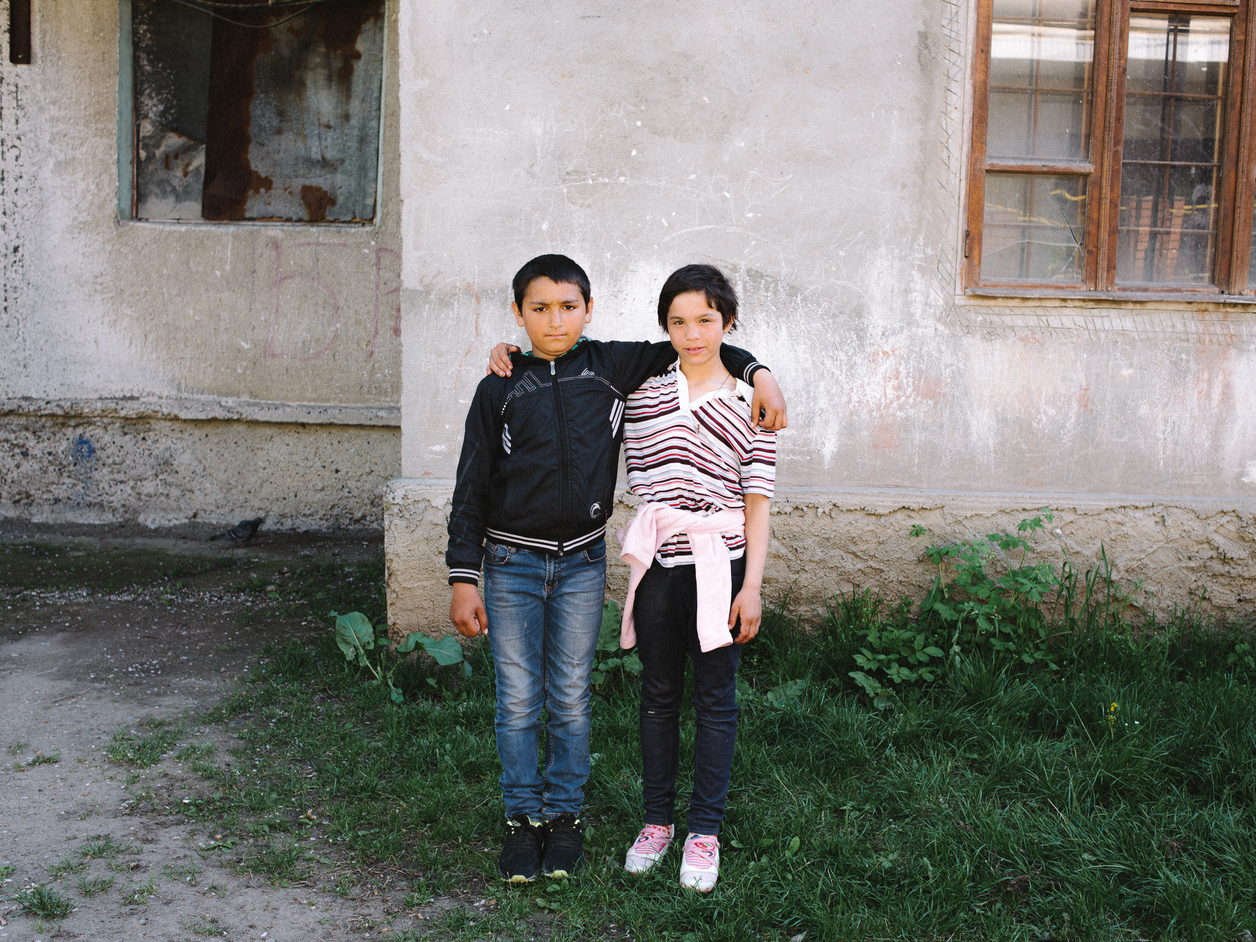 Matvej, 11, with his cousin, in front of their home, 'the Titanic'