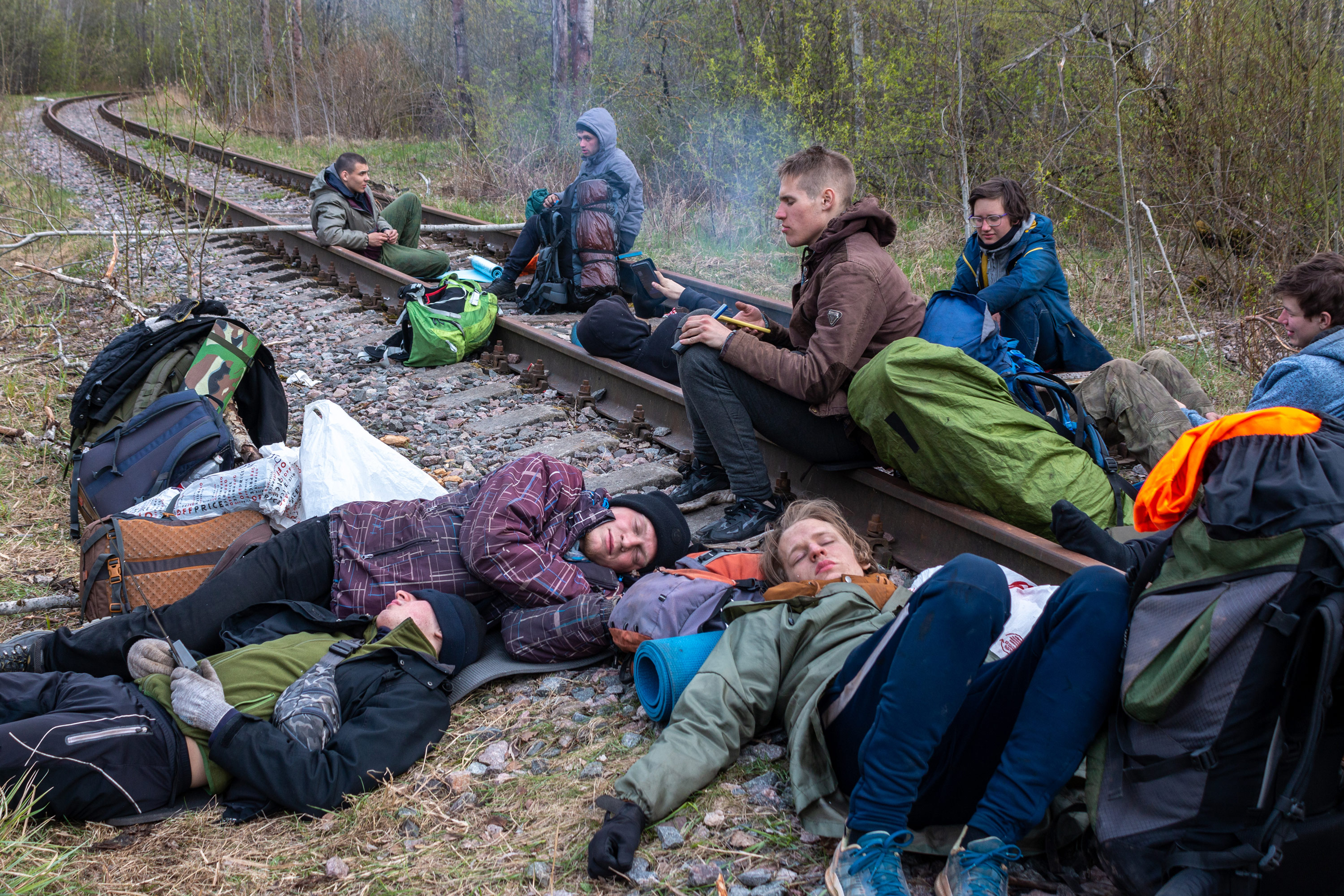The guys resting on the abandoned tracks waiting for the train to come. Sometimes the waiting takes up to 12 hours.