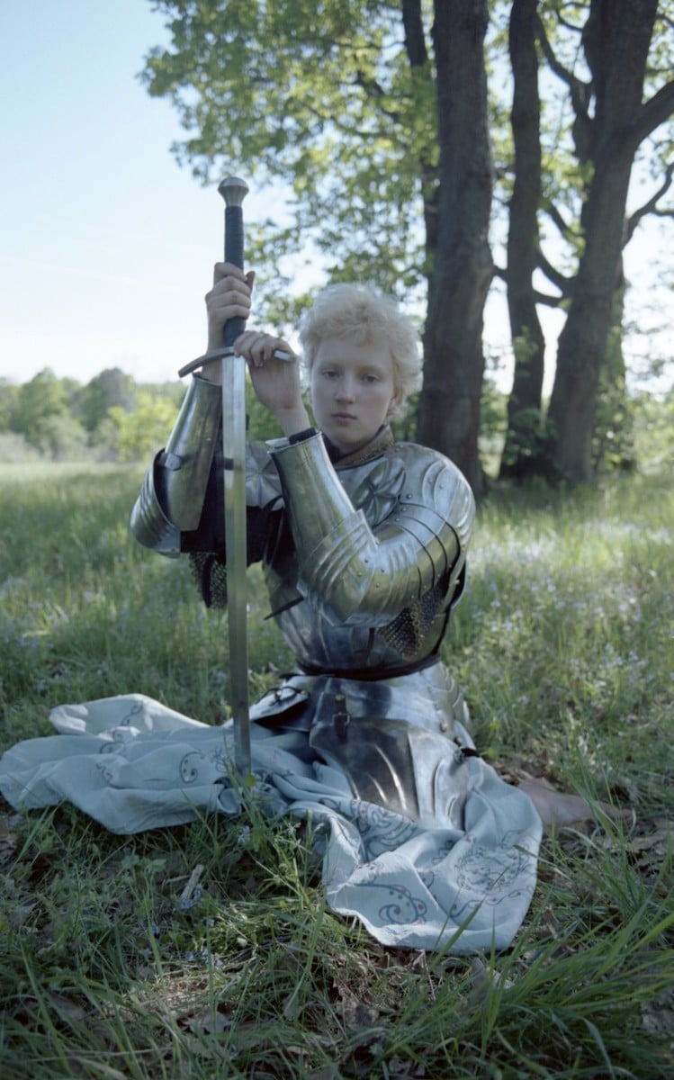 <p>Emerging photographer Ivan Vorobyov took this portrait at the age of 18 in 2019, in the village where he grew up. He describes this series as, “a slightly awkward but sincere ode to romanticism and happiness”. “Sonya, who is in this image, is also my teenage sweetheart. The armour was very heavy and she needed to rest in between shots. That’s when I took this photo, when she was resting before completing her next heroic deed”. </p>