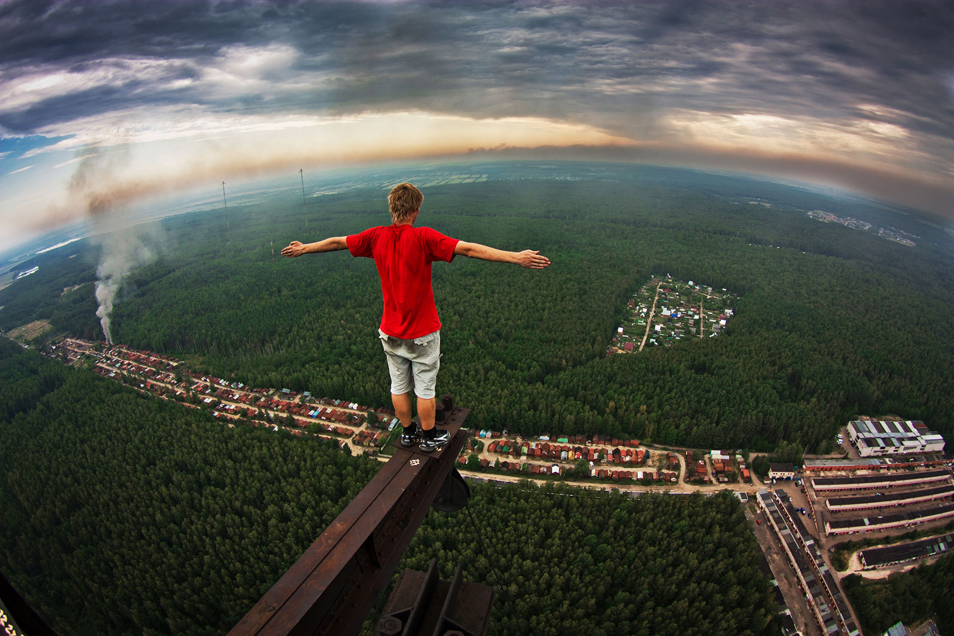 A friend of Marat Dupri balances on a steel beam over 200 metres above the Russian forest
