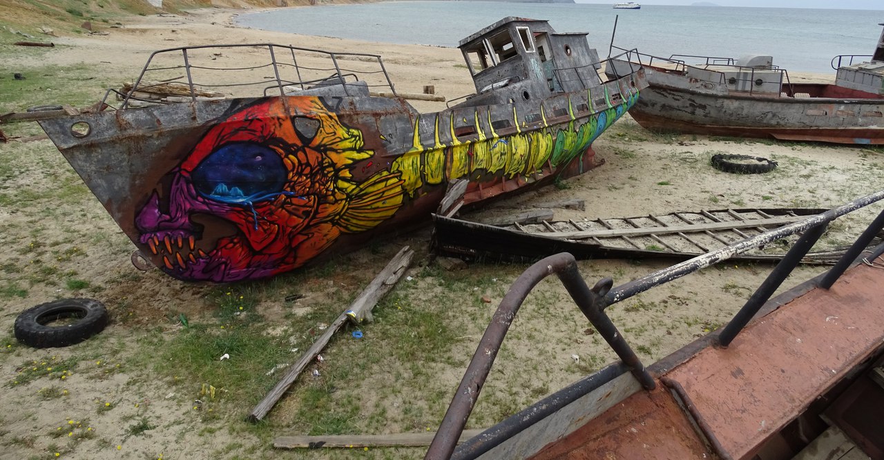 Rebirth. Old barge on the territory of a former fish factory