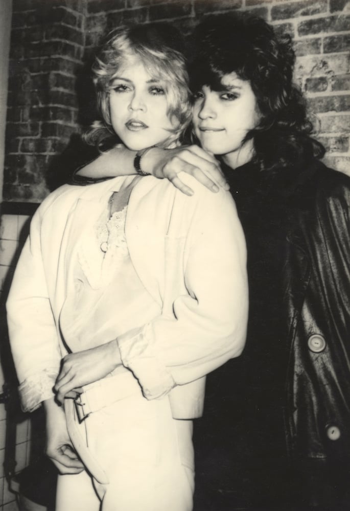 Supermodel Gia Carangi and makeup artist Sandy Linter in the men's room of Mudd Club, late 1970s