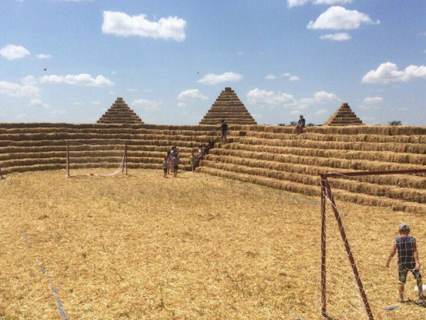 Russian farmers mock World Cup corruption with straw stadium